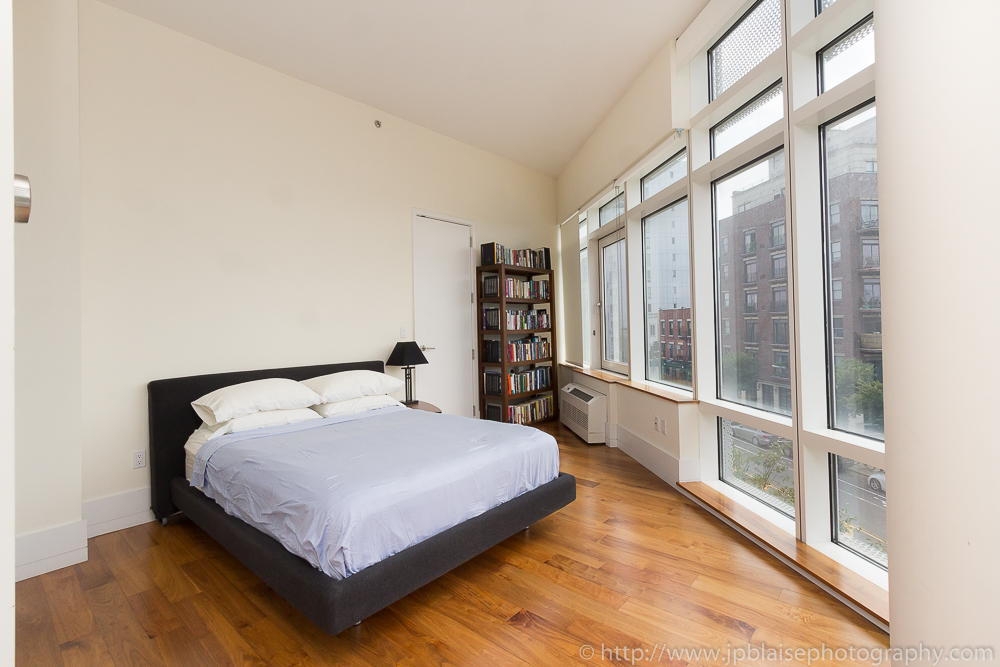 Bedroom photography with hardwood floors and large windows in Long Island City, Queens