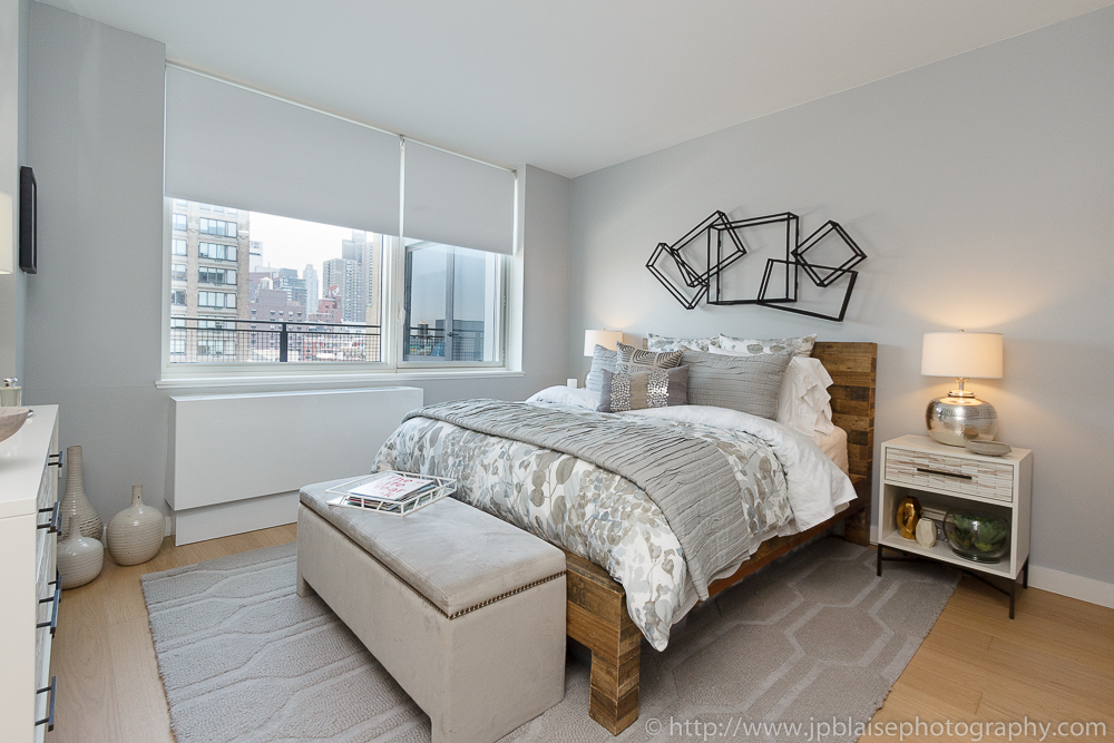 Real estate photographer: picture of the bedroom of a Midtown west one bedroom apartment, new york