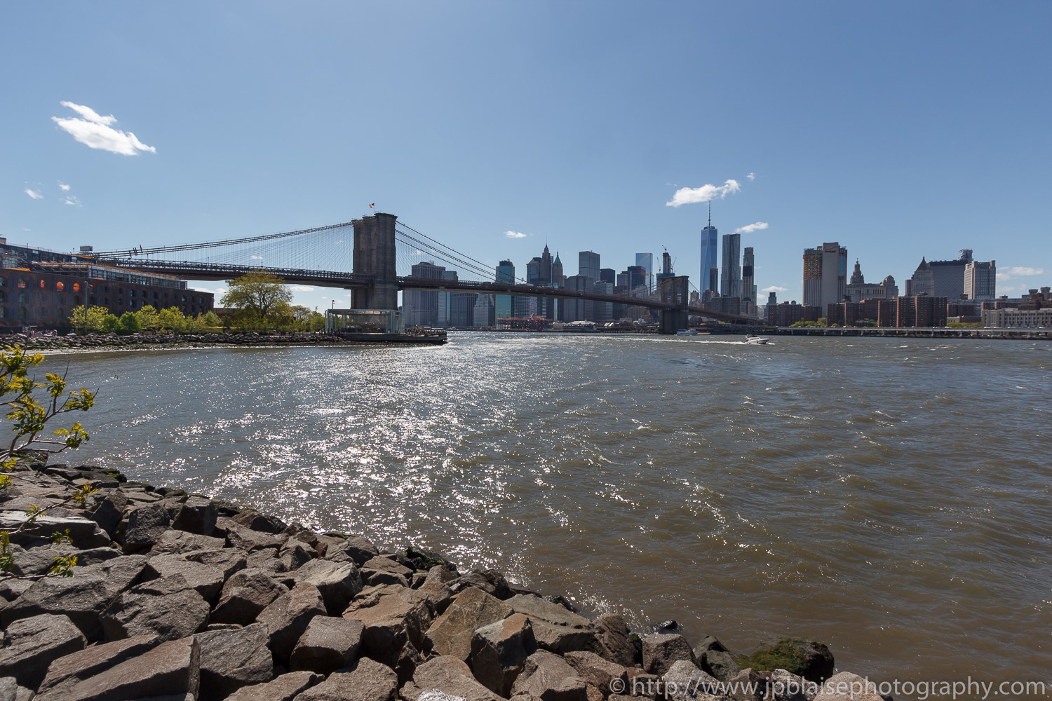 Real estate photographer work views of the manhattan bridge and the manhattan skyline from the brooklyn waterfront