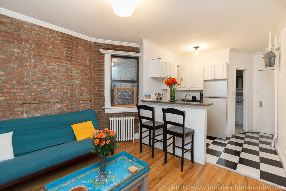 Open kitchen in beautiful Soho three bedroom apartment with exposed brick wall